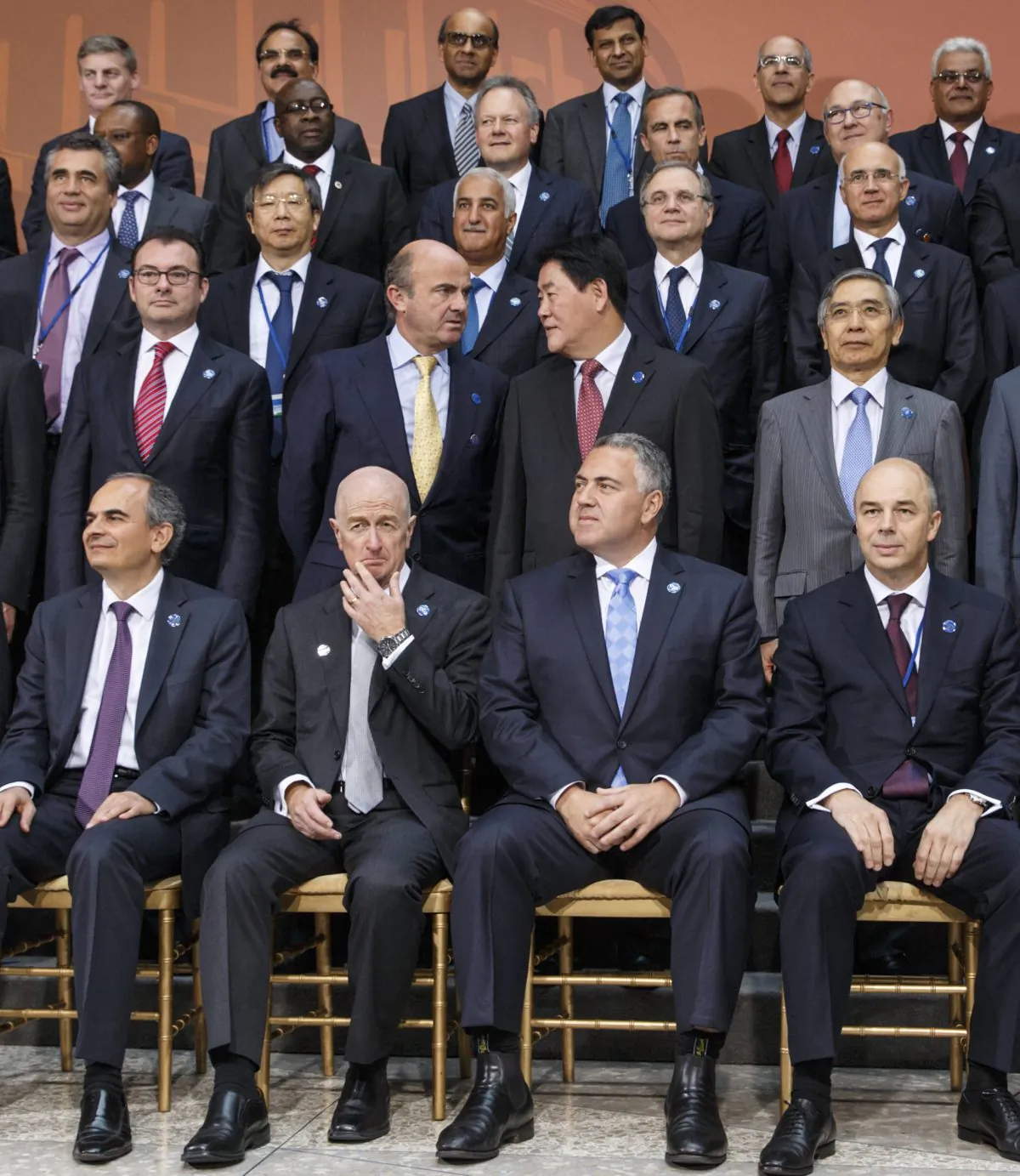 Finance ministers and central bank governors of the Group of Twenty nations gather for photo at the International Monetary Fund and World Bank meetings in Washington, Friday, Oct. 10, 2014. From left in front row are Erdem Basci, governor of the Central Bank of the Republic of Turkey, Glenn Stevens, Australia's central bank governor, Australia's Treasurer Joe Hockey who is chair of the G-20, and Russian Minister of Finance Anton Siluanov. (AP Photo/J. Scott Applewhite)