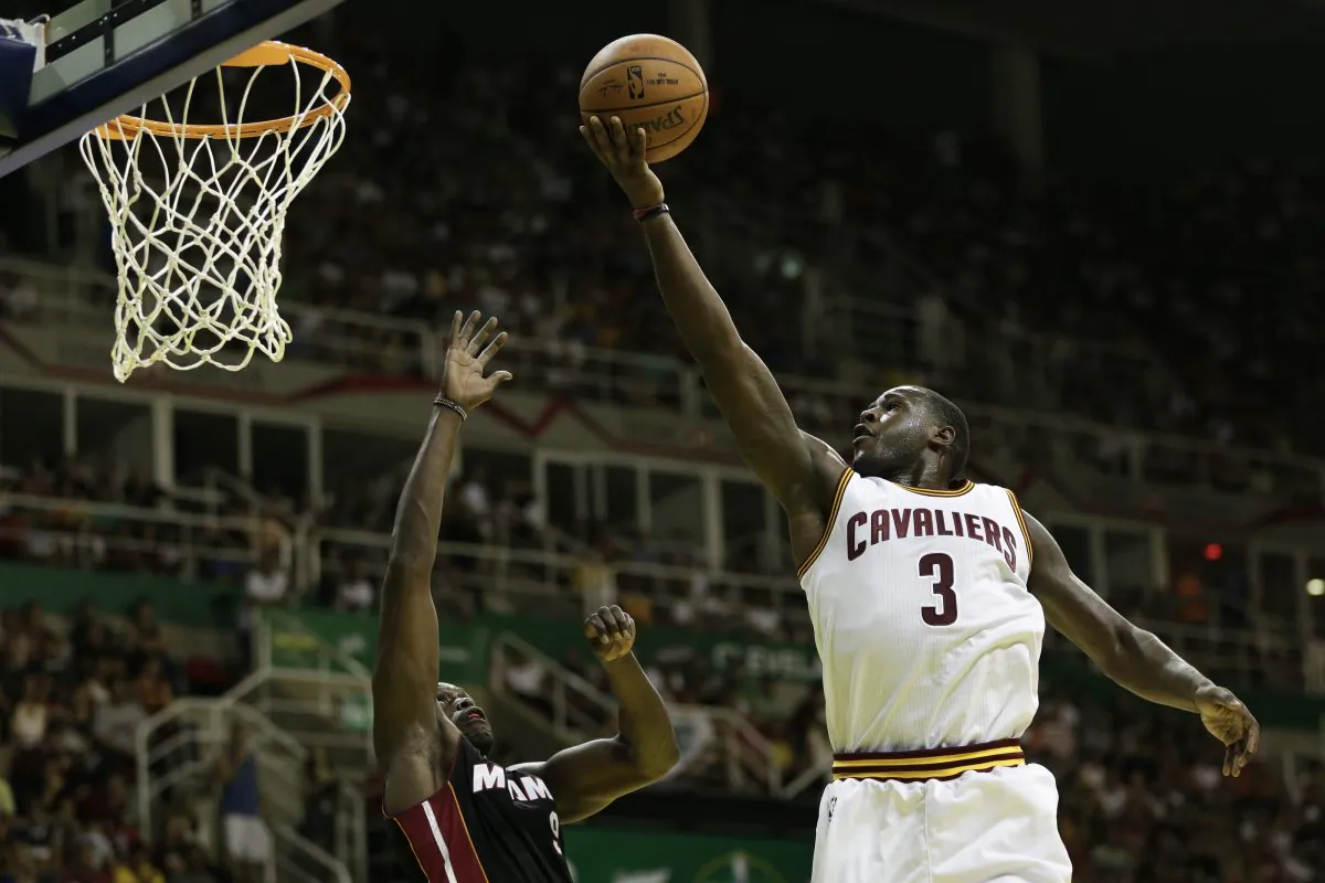 Cleveland Cavaliers' Dion Waiters shoots over Miami Heat's Luol Deng at a NBA preseason basketball game that's part of the NBA Global Games in Rio de Janeiro, Brazil, Saturday, Oct. 11, 2014. (AP Photo/Felipe Dana)