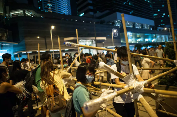 Pro-democracy protesters erect bamboo barricades on October 13, 2014 at Admiralty district in Hong Kong. Pro-democracy supporters continue to occupy the streets surrounding Hong Kong's Financial district after talks broke down with the government. Protesters have threatened to widen their campaign as they continue to call for open elections and the resignation of Hong Kong's Chief Executive Leung Chun-ying. (Photo by Anthony Kwan/Getty Images)