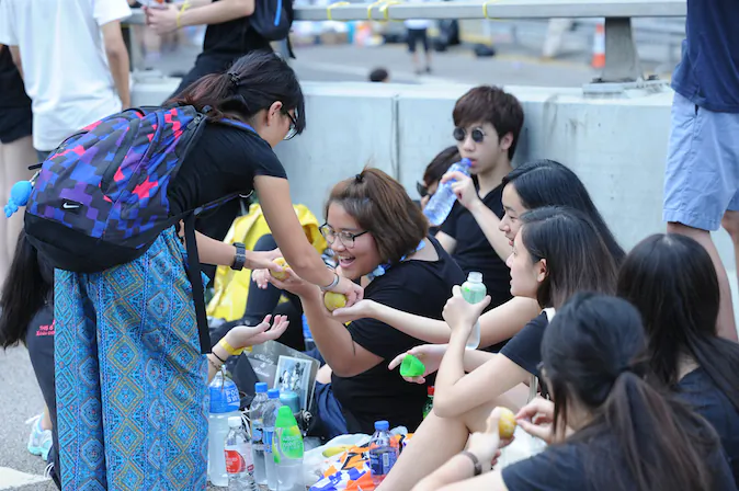 A lady hands out food to the Hong Kong Occupy Central protestors. (Liang Jia-wen/Epoch Times)