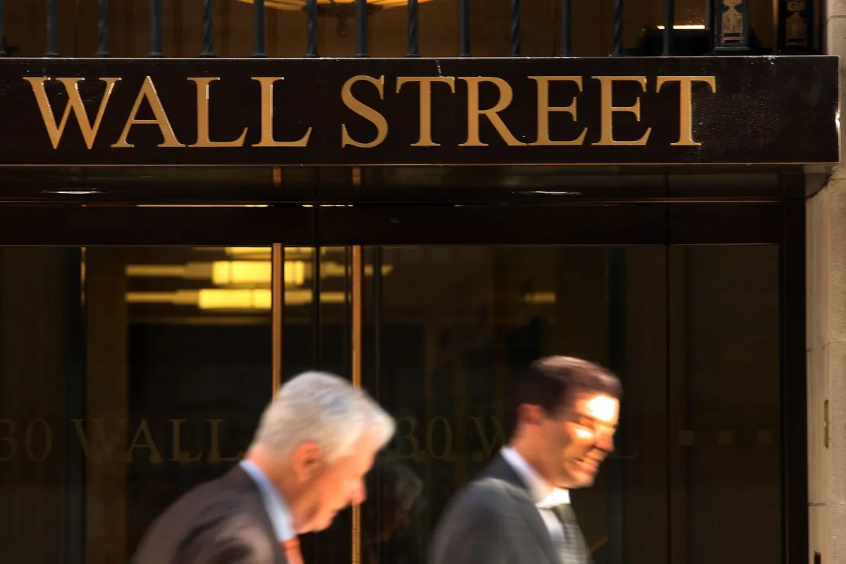 People walk down Wall Street on Oct. 14, 2014, in New York City. (Spencer Platt/Getty Images)