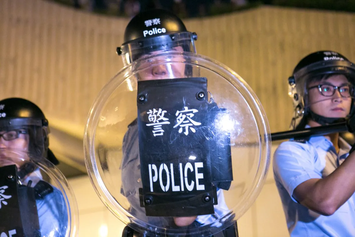 Pro-democracy protesters clash with police after while trying to block off Lung Wo Road, one of the major roadways in Hong Kong, in retaliation after the police removed barriers and opened an occupied road earlier today, on Oct. 14, 2014. (Benjamin Chasteen/Epoch Times)