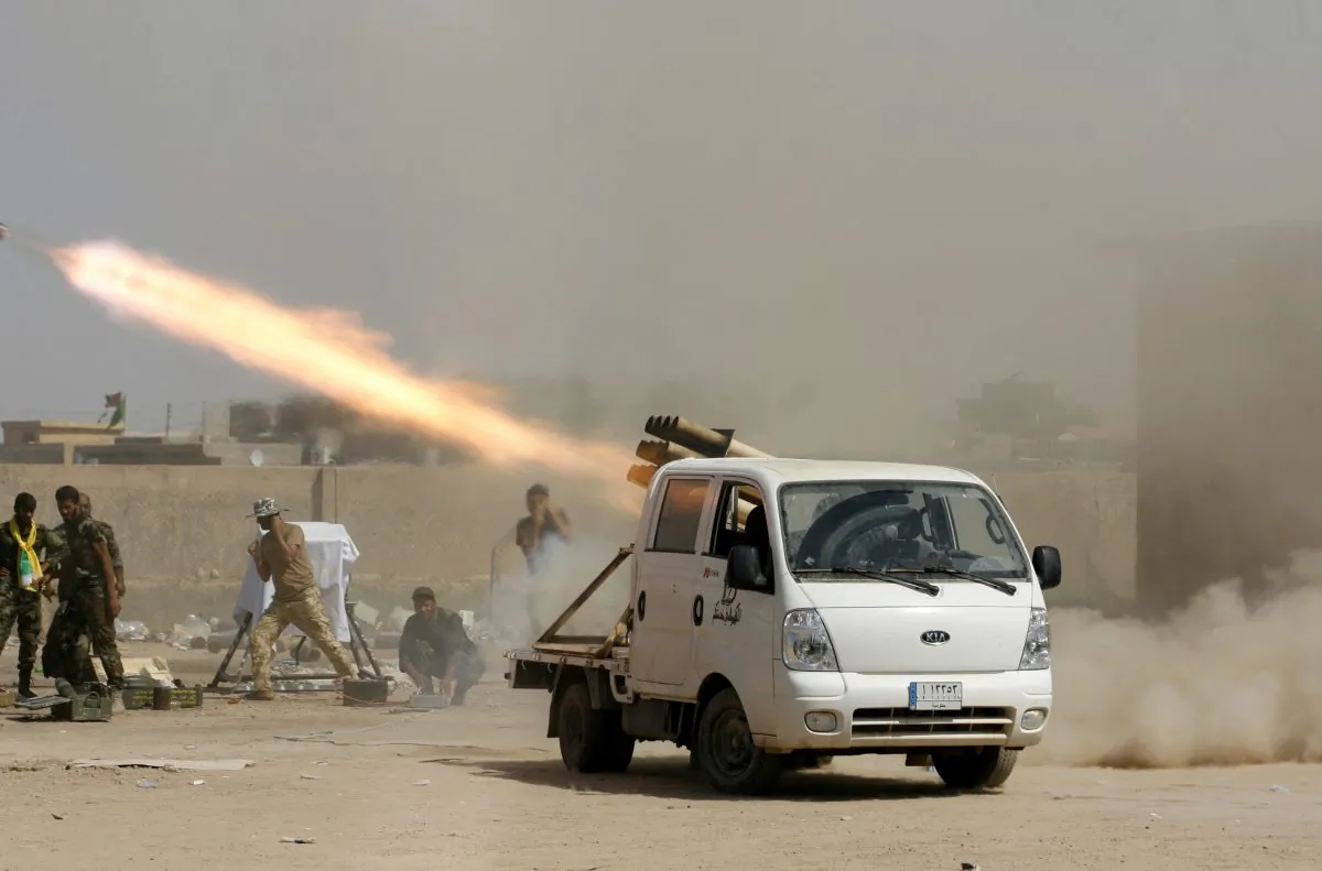 Iraqi security forces and Shiite militiamen fire at Islamic State group positions during an operation outside Amirli, some 105 miles (170 kilometers) north of Baghdad, Iraq, on Sept. 3, 2014. Iraqs Shiite militias have abducted and killed scores of Sunni civilians in retaliation for the onslaught by the Sunni militant Islamic State group, Amnesty International said Tuesday, Oct. 14, 2014, claiming that the attacks are supported by the Shiite-led government in Baghdad. After Iraq's second-largest city, Mosul, fell to the militants in June, then-Prime Minister Nouri al-Maliki called upon volunteers to reinforce the humiliated military, and many Shiite militias quickly reported for duty. (AP Photo)