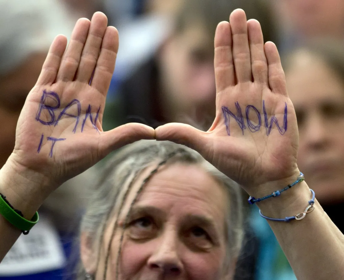 Hydraulic fracturing, or "fracking" opponent Chrys Countryman of Afton, N.Y., holds her hands up as Joe Martens, commissioner of the New York State Department of Environmental Conservation, testifies before a joint budget hearing in Albany, N.Y., Feb. 4, 2013. New York politicians and voters alike are weigh in on whether to allow hydraulic fracturing for natural gas. (AP Photo/Mike Groll)