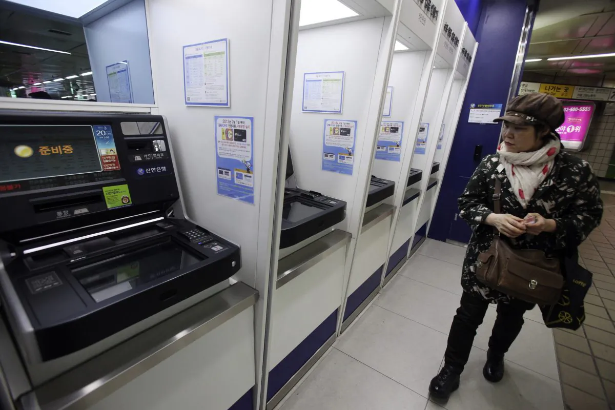 A depositor leaves after checking her account through an automated teller machine at a subway station as the bank's computer networks was paralyzed in Seoul, South Korea, on March 20, 2013. After an avalanche of data breaches, South Korea’s national identity card system has been raided so thoroughly by thieves that the government says it might have to issue new ID numbers to every citizen over 17 at a possible cost of billions of dollars. (AP Photo/Ahn Young-joon)