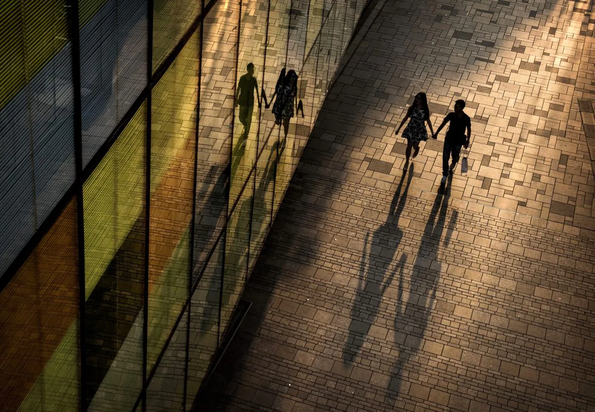 A Chinese couple walk together while shopping at an outdoor mall in the evening on Sept. 5, 2014, in Beijing, China. The Obama administration said Wednesday that China's currency remains "significantly undervalued." (Kevin Frayer/Getty Images)