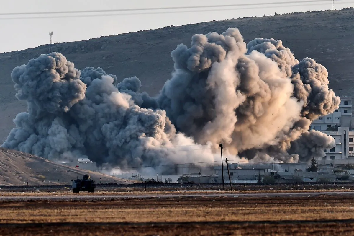 Smoke rises during airstrikes on the Syrian town of Ain al-Arab, known as Kobani by the Kurds, seen from the Turkish-Syrian border in the southeastern village of Mursitpinar, Sanliurfa province, on Oct. 8, 2014. (Aris Messinis/AFP/Getty Images)