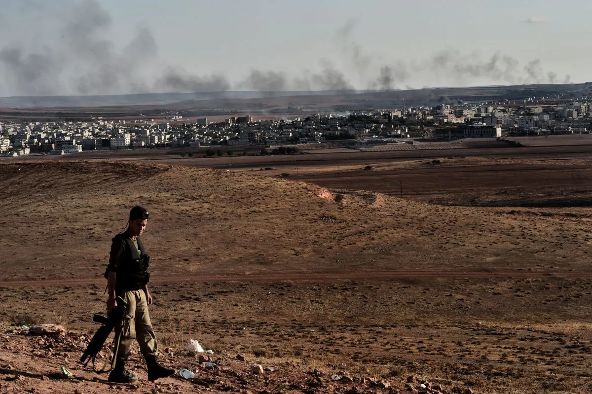 A Turkish soldier patrols a hill overlooking the Syrian town of Kobani, also known as Ain al-Arab, in the southeastern village of Mursitpinar, Sanliurfa province, on Oct. 15, 2014. US warplanes hit Islamic State jihadists with 18 bombing raids near the Syrian town of Kobani on Oct. 14 and 15, to support besieged Kurdish militia there, US Central Command said. The latest raids targeted several IS positions and 16 buildings occupied by the group, the military said. (Aris Messinis/AFP/Getty Images)