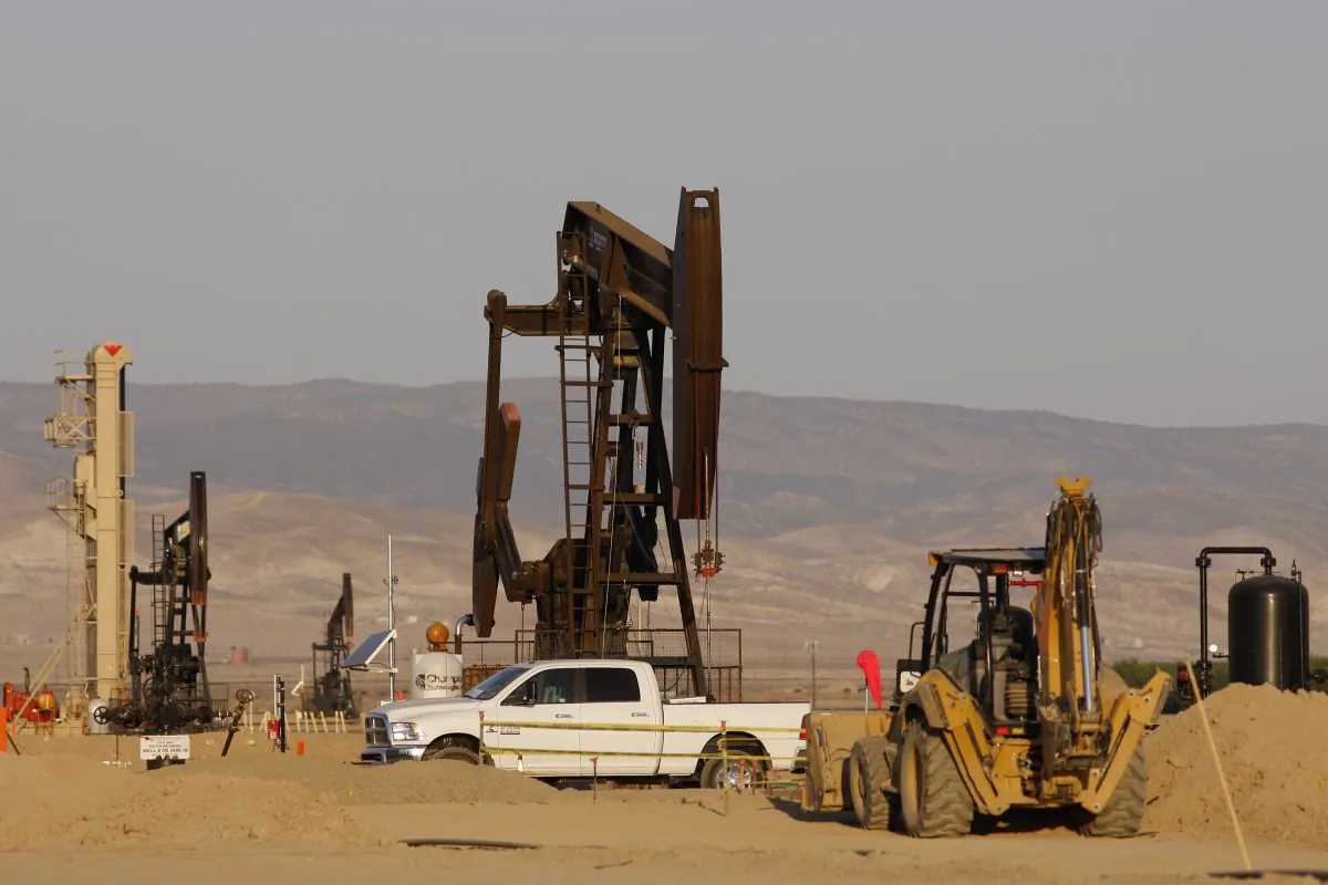 Pump jacks stand in fields that are being developed for drilling next to a farm over the Monterey Shale formation where gas and oil extraction using fracking is booming near Lost Hills, Calif. (David McNew/Getty Images)