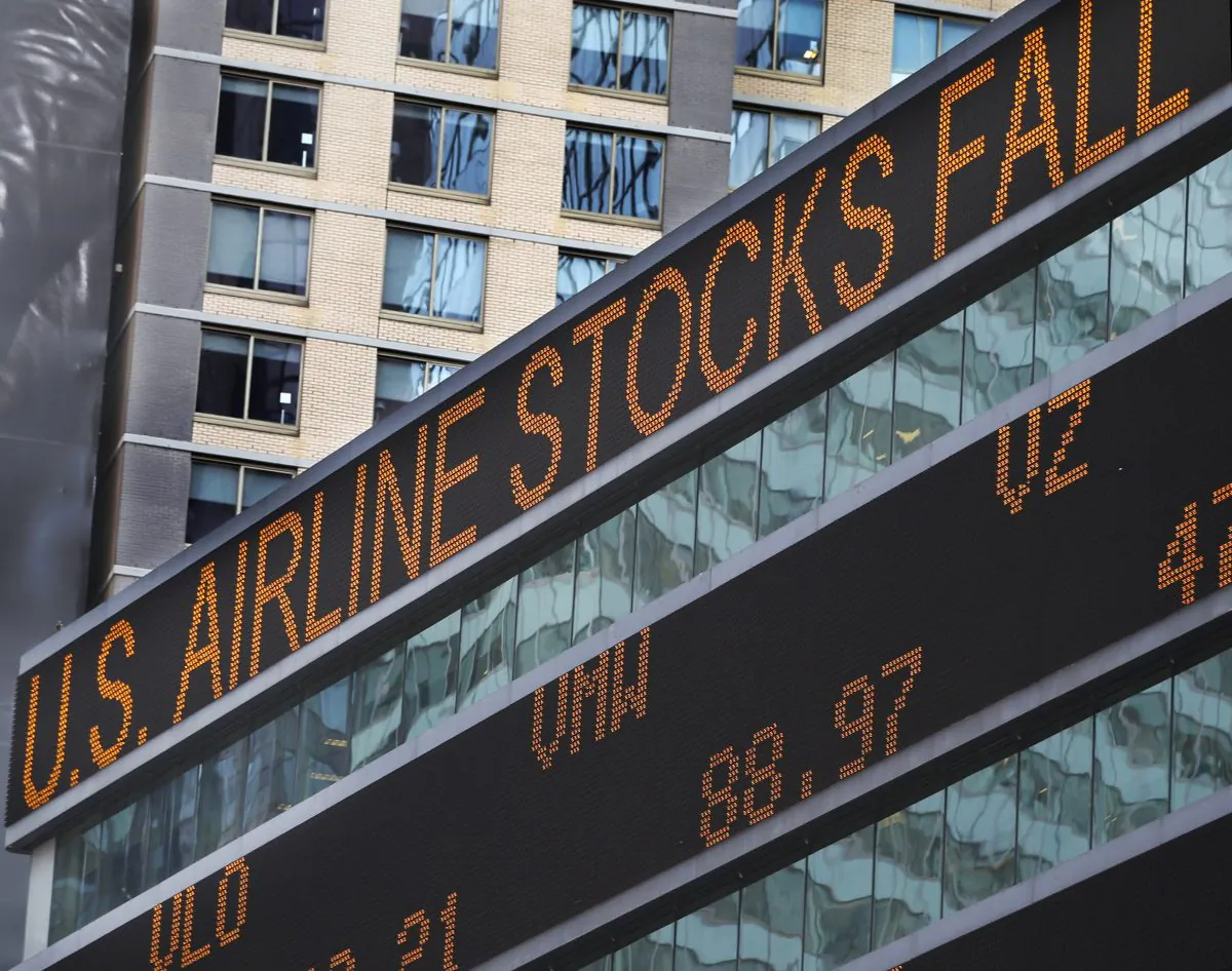 A financial news zipper on the front of Morgan Stanley's world headquarters shows news of US airline stocks falling on news of fears of traveling due to Ebola, Wednesday, Oct. 15, 2014, in New York. (AP Photo/Kathy Willens)