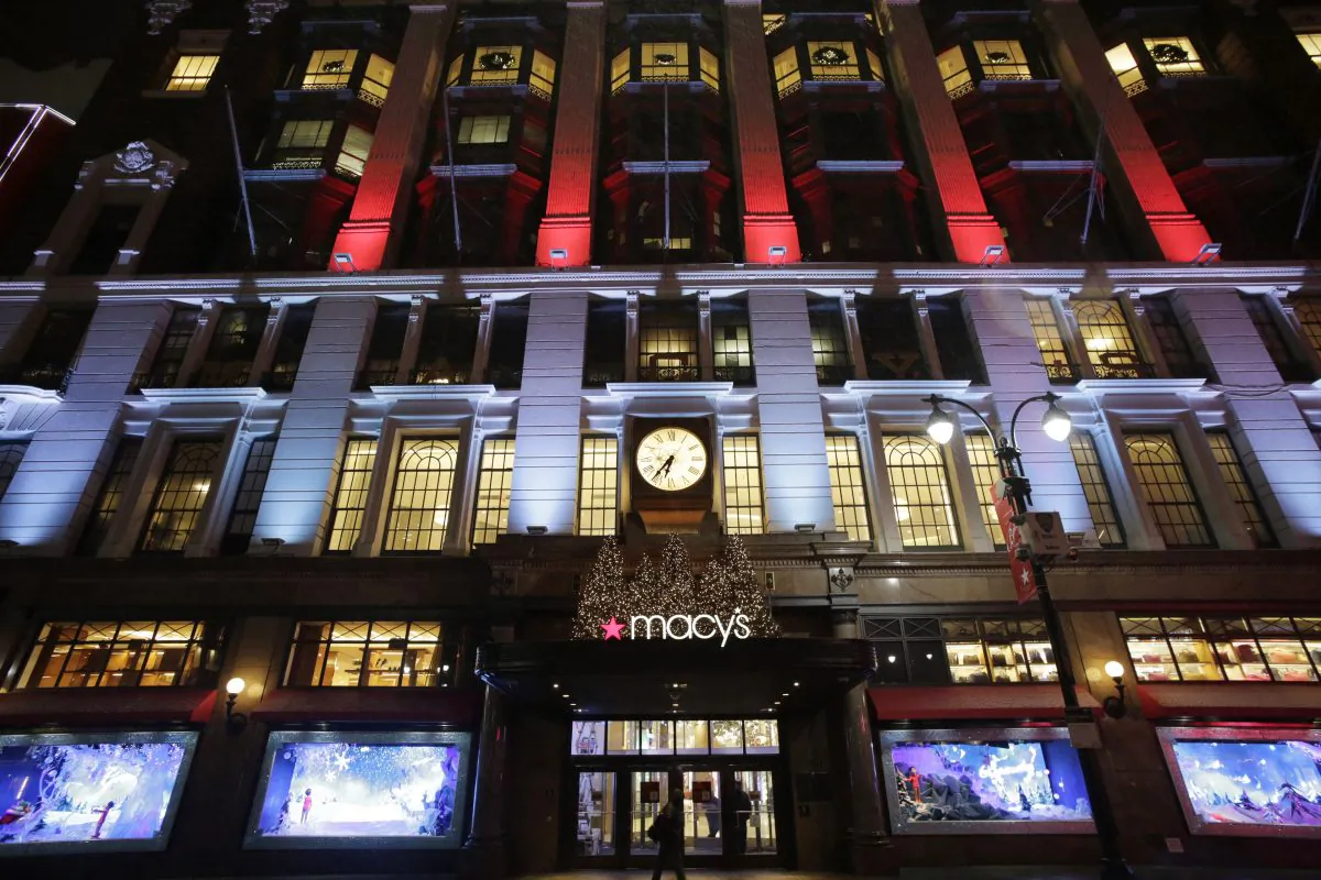 Macy's department store in Herald Square is illuminated with holiday lighting, in New York, Tuesday, Dec. 17, 2013. Macy's Inc. plans to open its stores at 6 p.m. on Thanksgiving Day, two hours earlier than last year. (AP Photo/Mark Lennihan)