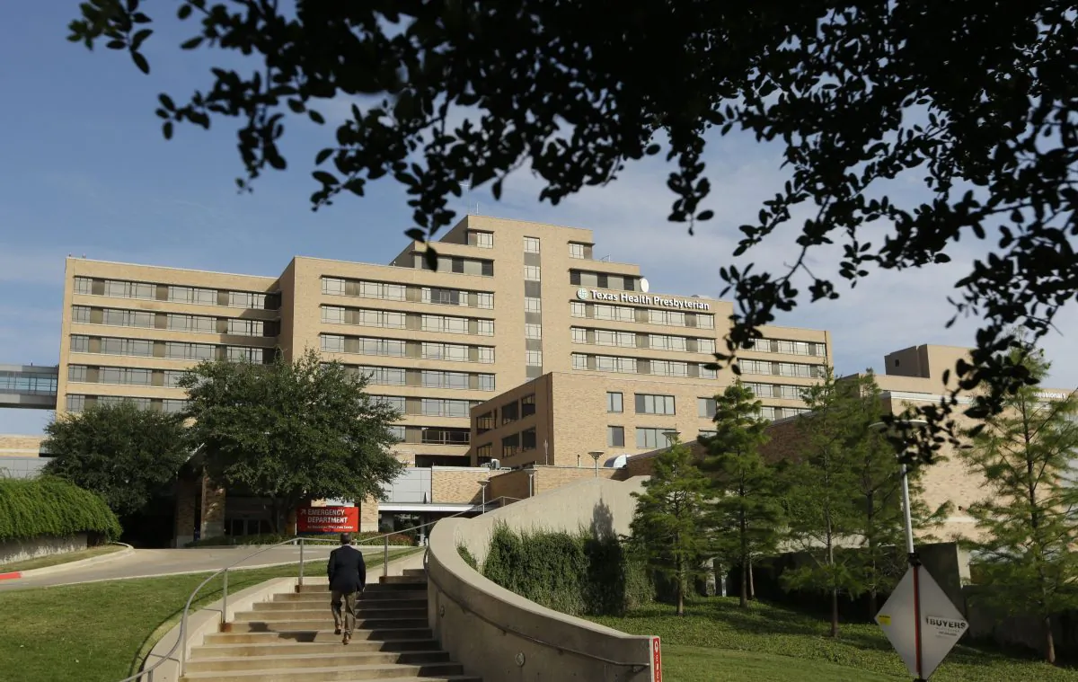 FILE - A man walks up the stairway leading to the Texas Health Presbyterian Hospital in Dallas, in this Tuesday, Sept. 30, 2014 file photo. The Texas health department statement Wednesday Oct. 15, 2014 said a second health care worker tests positive for Ebola. (AP Photo/LM Otero, File)