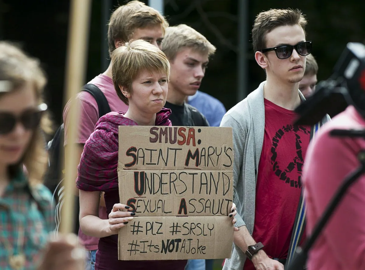 Students attend a rally at Saint Mary’s University in Halifax to express their concerns over a chant that promoted rape culture, Sept. 12, 2013. The chant, captured on video and posted on social media, was sung at a frosh-week event for about 400 new students at the school. (The Canadian Press/Andrew Vaughan)