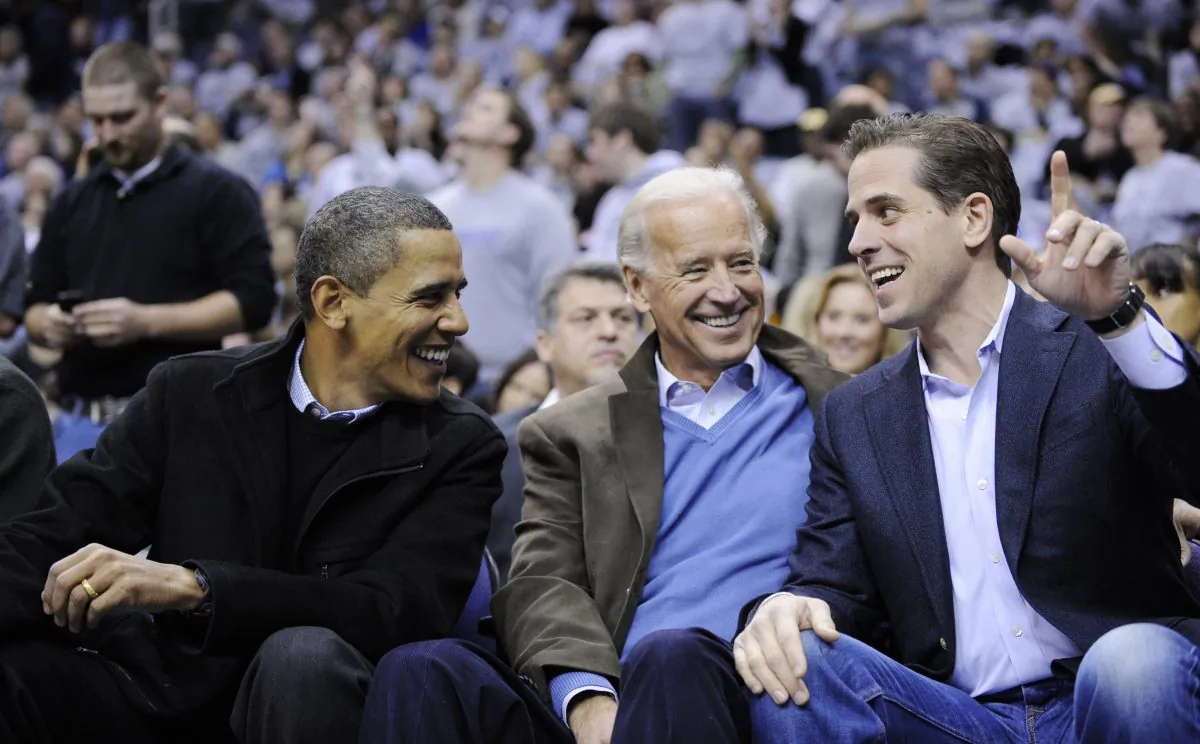 L-R: Former President Barack Obama, former Vice President Joe Biden, and his son Hunter Biden, at a college basketball game in Washington on Jan. 30, 2010. (Nick Wass/AP Photo)