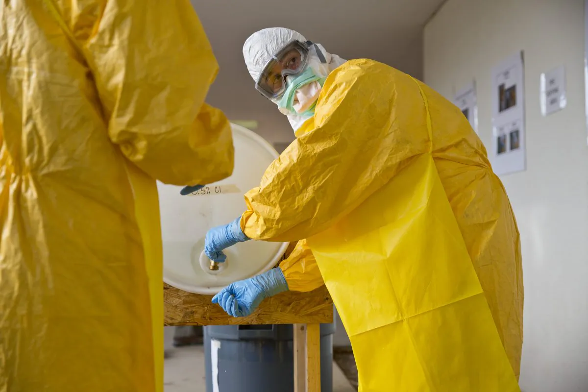 A licensed clinician sanitizes his hands after a simulated training session  in Anniston, Ala. on Oct. 6, 2014. The Centers for Disease Control and Prevention (CDC) has developed an introductory training course for licensed clinicians. According to the CDC, the course is to ensure that clinicians intending to provide medical care to patients with Ebola have sufficient knowledge of the disease. (AP Photo/Brynn Anderson)
