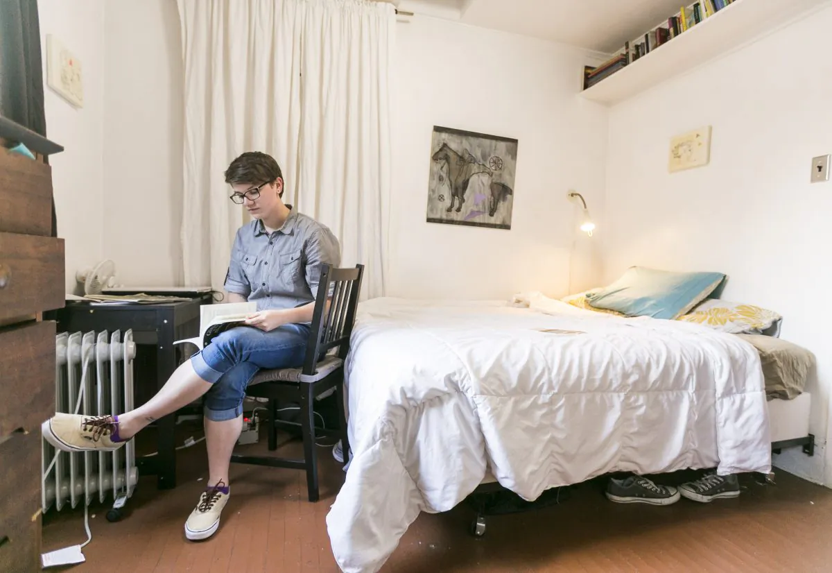 Airbnb guest Megan Walsh reads in her room at the Echo Park home of artist Jonathan Entler, in Los Angeles, May 19, 2014. The vast majority of Airbnb listings are illegal, and "multi-million dollar businesses" of illegal hotel rentals are being run out of the most "gentrified neighborhoods" of New York City, according to a report Attorney General Eric Schneiderman released Oct. 16.
(AP Photo/Damian Dovarganes)