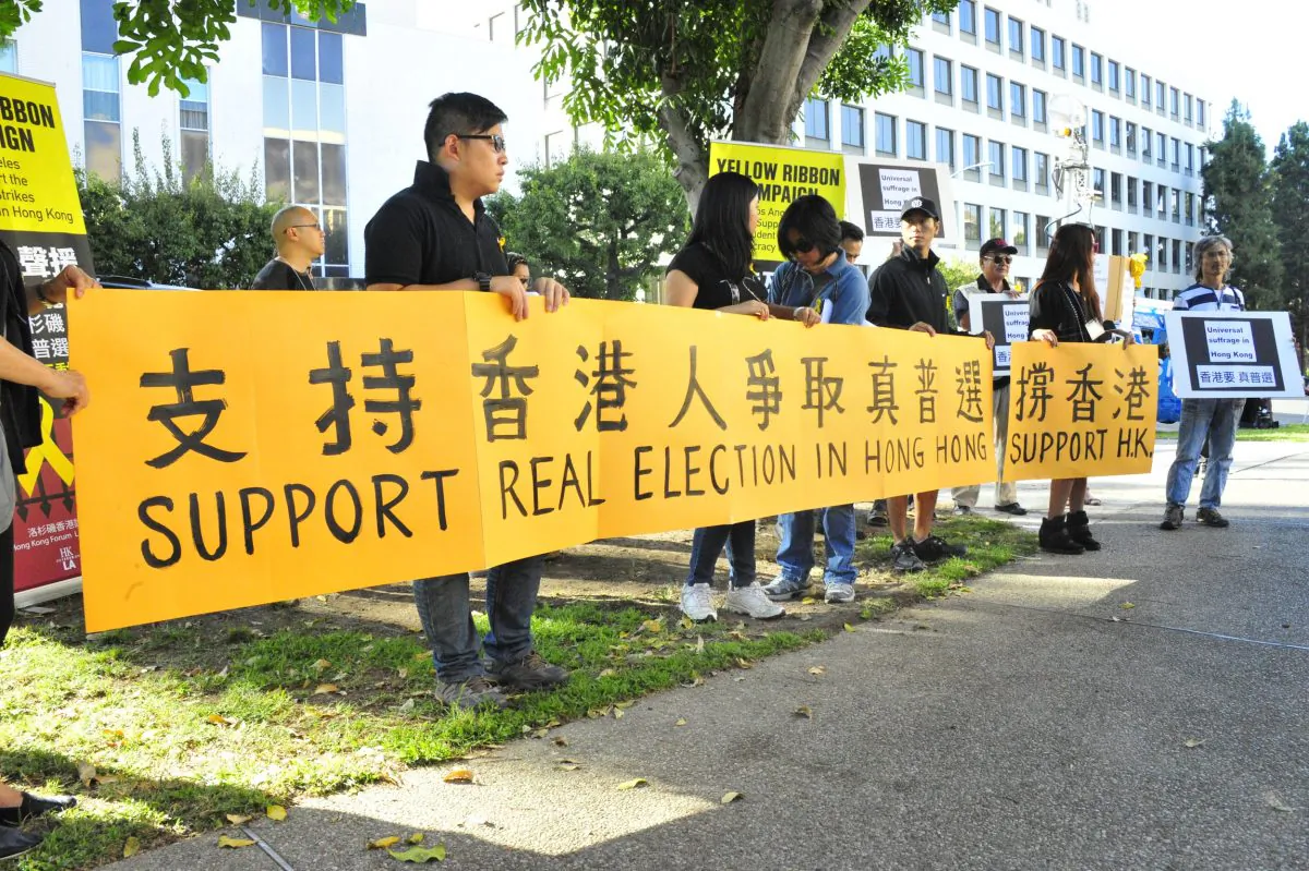 Nearly 100 protesters gathered to protest the CCP's abuse of students and to fight for Hong Kong's suffrage. (Robin Kemker\Epoch Times)