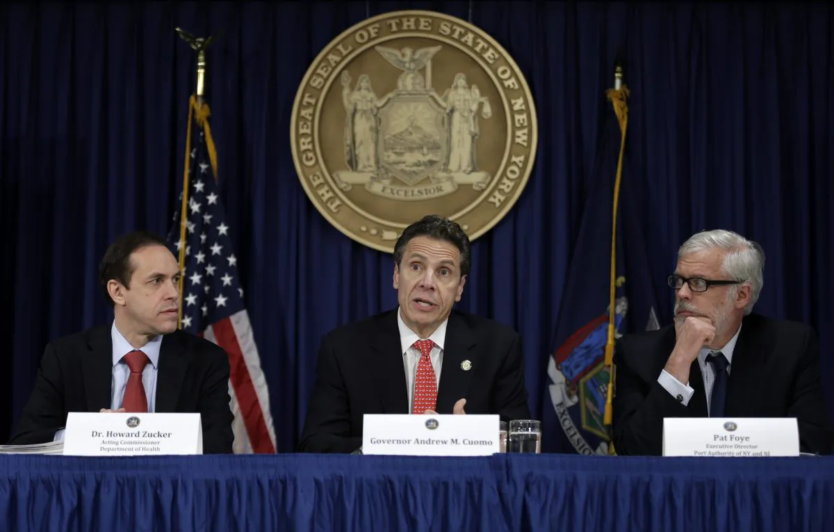 New York Gov. Andrew Cuomo (C), speaks while the acting Commissioner of the Department of Health Howard Zucker (L), and Executive Director of the Port Authority Pat Foye listen during a news conference in New York, Oct. 16, 2014. Cuomo said that eight hospitals across the state are especially prepared with go-to teams who've been drilled in anti-Ebola protocols. In addition, officials said public transportation systems including New York City's subways and buses are on the alert for possible passengers carrying the virus. (AP Photo/Seth Wenig)