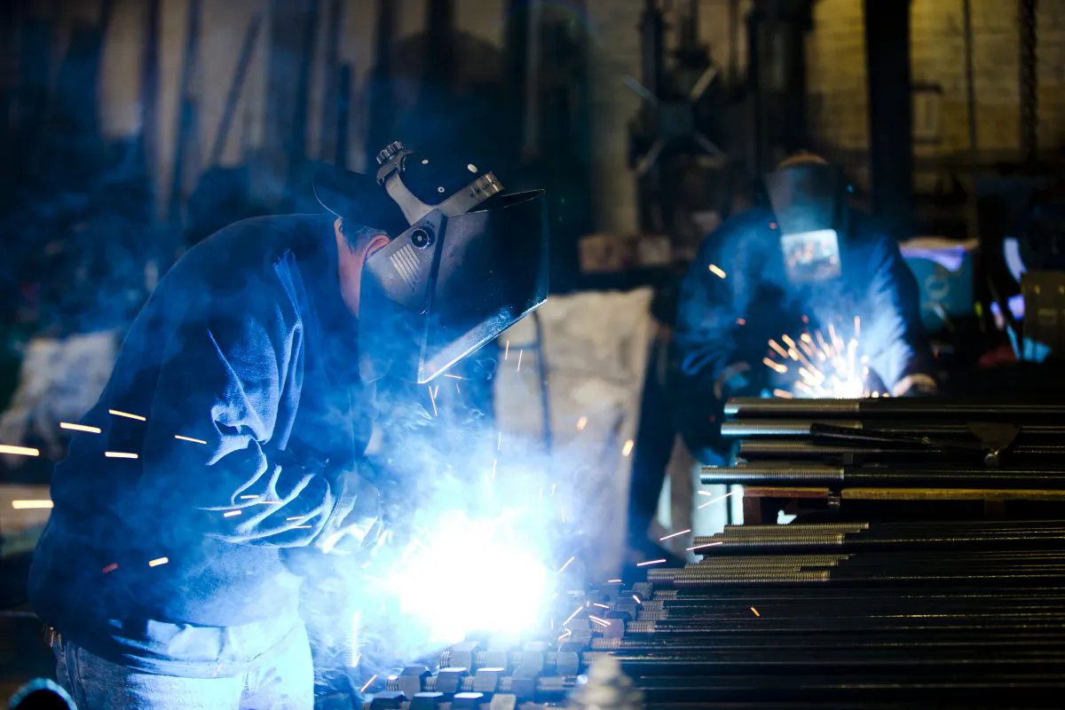 Welders fabricate anchor bolts for roads and bridges at the custom manufacture Fox Company Inc., in Philadelphia, on July 16, 2014. Beyond the turmoil shaking financial markets, the US economy remains sturdier than many seem to fear. (AP Photo/Matt Rourke)