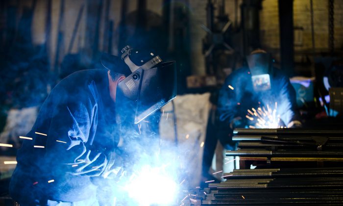 Welders fabricate anchor bolts for roads and bridges at the custom manufacture Fox Company Inc., in Philadelphia, on July 16, 2014. Beyond the turmoil shaking financial markets, the US economy remains sturdier than many seem to fear. (AP Photo/Matt Rourke)