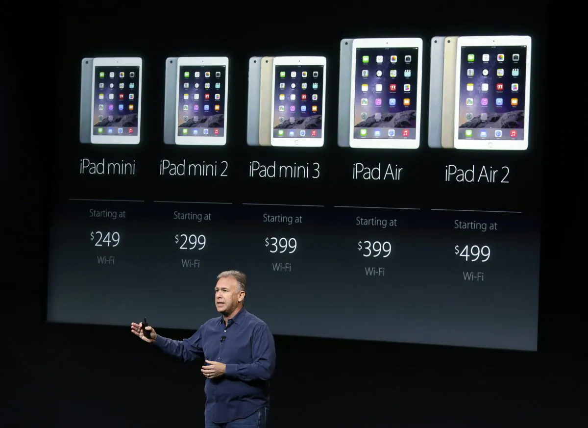 Phil Schiller, Apple's senior vice president of worldwide product marketing, discuss the pricing of the Apple iPad line-up during an event at Apple headquarters on Thursday, Oct. 16, 2014 in Cupertino, Calif. (AP Photo/Marcio Jose Sanchez)