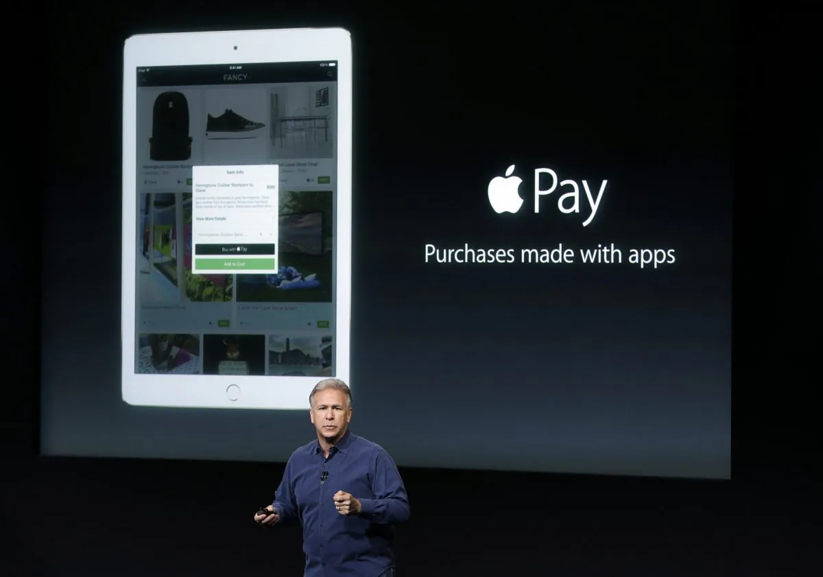 Phil Schiller, Apple's senior vice president of worldwide product marketing, discuss the features of the new Apple iPad Air 2 and Apple Pay during an event at Apple headquarters in Cupertino, Calif. on Thursday, Oct. 16, 2014. (AP Photo/Marcio Jose Sanchez)