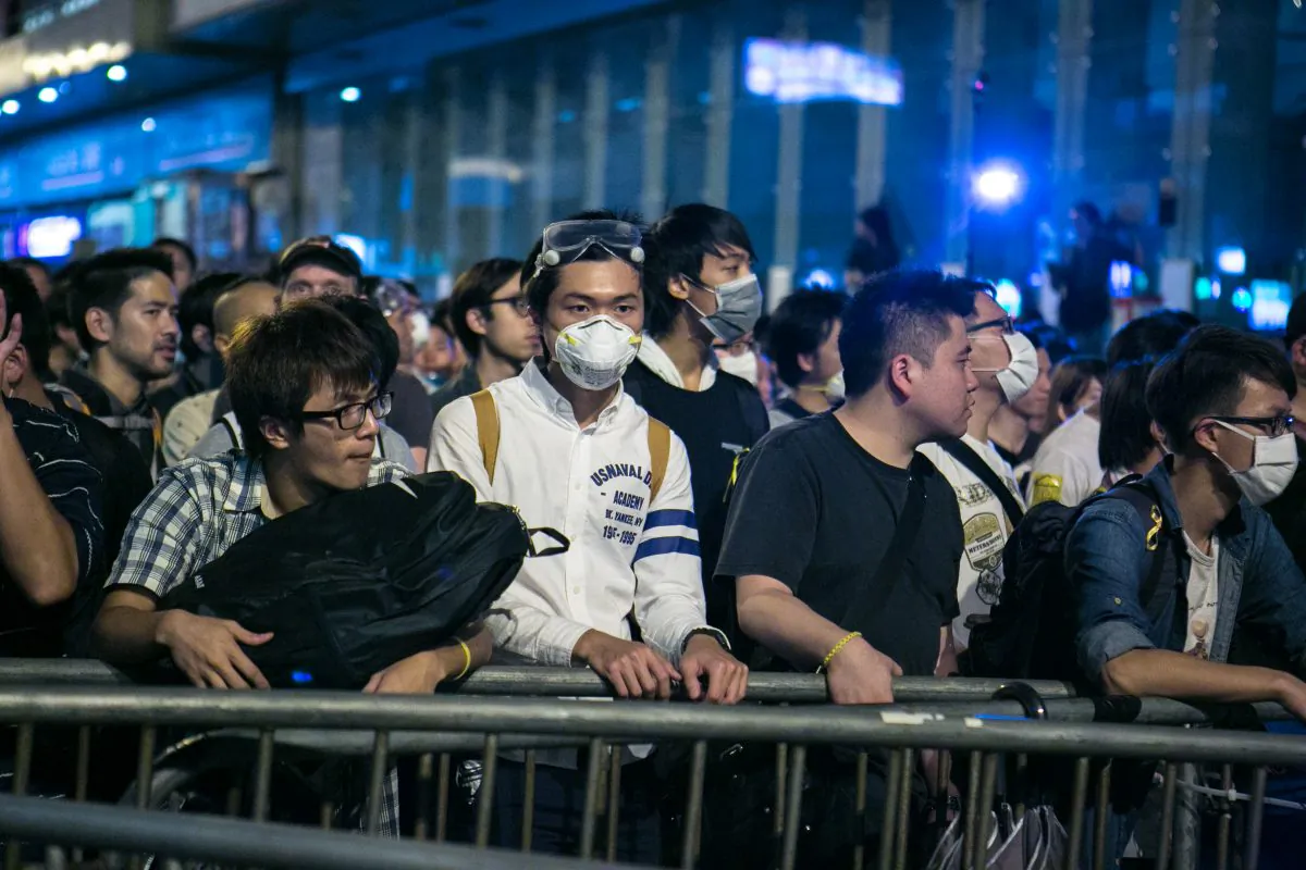 Pro-democracy protesters successfully occupy a portion of Argyle Street after repeatedly failed attempts in Mong Kok, Hong Kong,  on Oct. 18, 2014. (Benjamin Chasteen/Epoch Times)