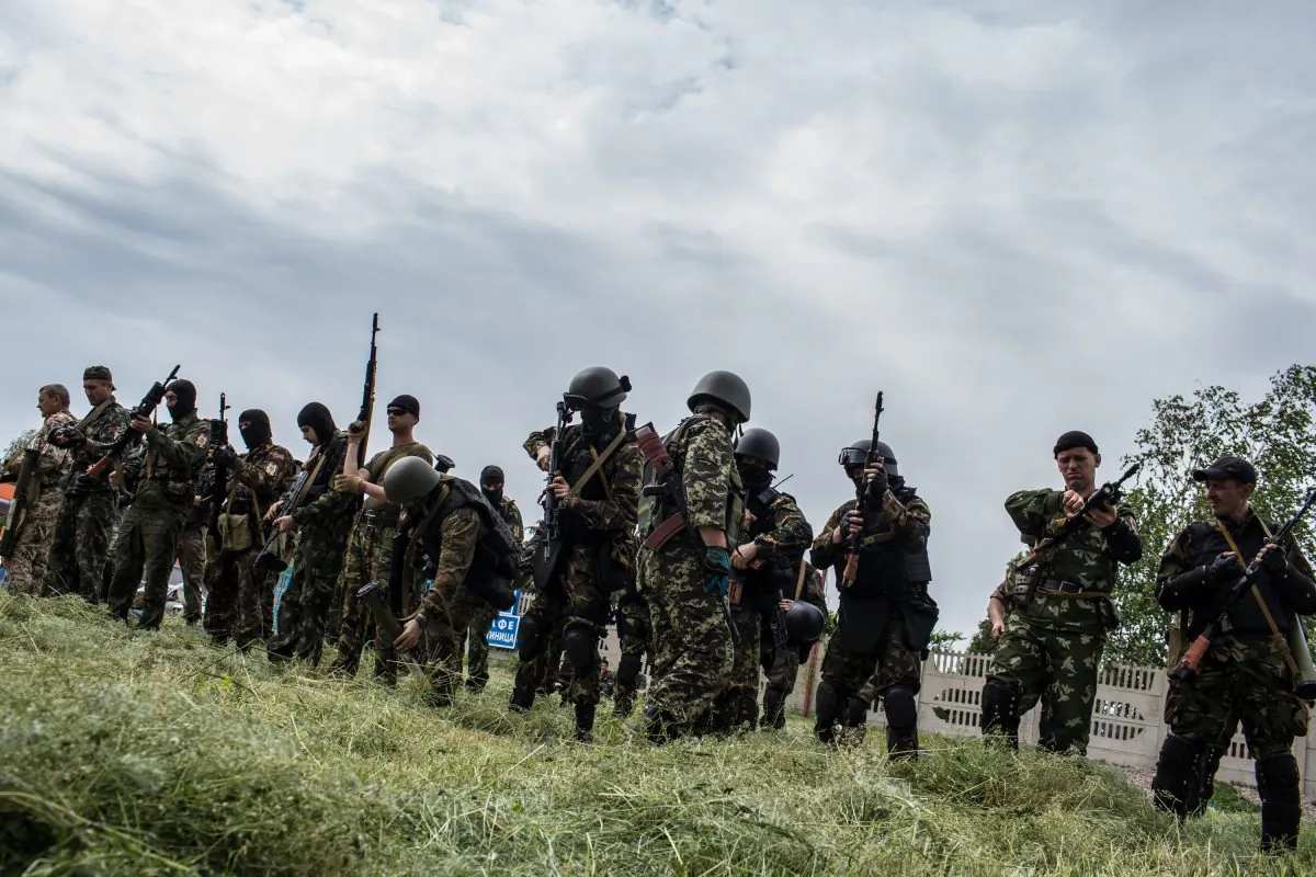 Members of the pro-Russia Vostok Battalion assemble along the side of the road following early morning clashes with Ukrainian fighters on May 23, 2014, in Pisky, Ukraine. (Brendan Hoffman/Getty Images)