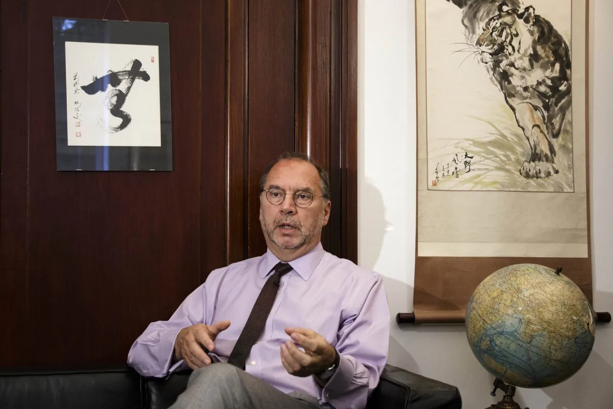 Dr. Peter Piot, the co-discoverer of the Ebola virus, speaks during an interview with The Associated Press at his office at the London School of Hygiene and Tropical Medicine in London, Friday, Oct. 17, 2014. Piot questioned why it took the World Health Organization five months and 1,000 deaths before the agency declared Ebola an international health emergency in August. (AP Photo/David Azia)