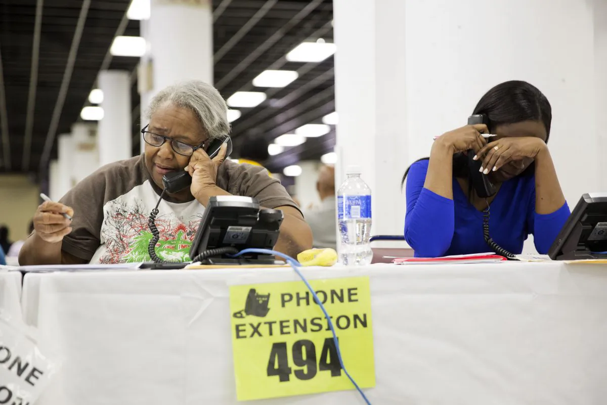 Homeowners speak to mortgage associates with the Neighborhood Association Corporation of America in an attempt to lower their monthly mortgage payments at a mortgage relief event, Tuesday, Sept. 30, 2014, in Atlanta. The event gives homeowners the opportunity to meet face to face with their lender in the hopes of dropping their interest rates for a reduced monthly payment. Several thousand have attended the five-day event which ends Tuesday. Georgia currently has the highest unemployment rate in the country and a foreclosure rate higher than the national average. (AP Photo/David Goldman)