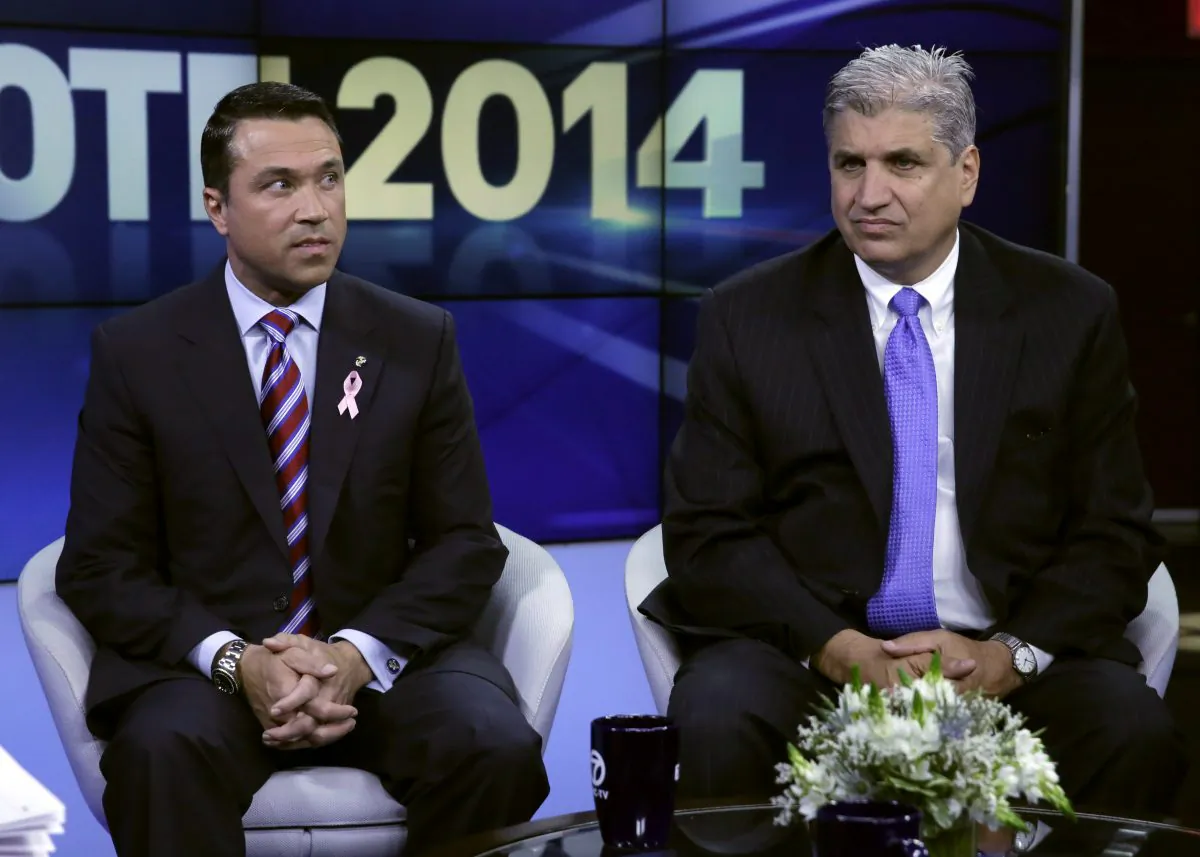 Republican Congressman Michael Grimm (L) and Democratic opponent Domenic M. Recchia Jr. wait for their debate to start in the studios of WABC-TV in New York City, Oct. 17, 2014. (Richard Drew-Pool/Getty Images)