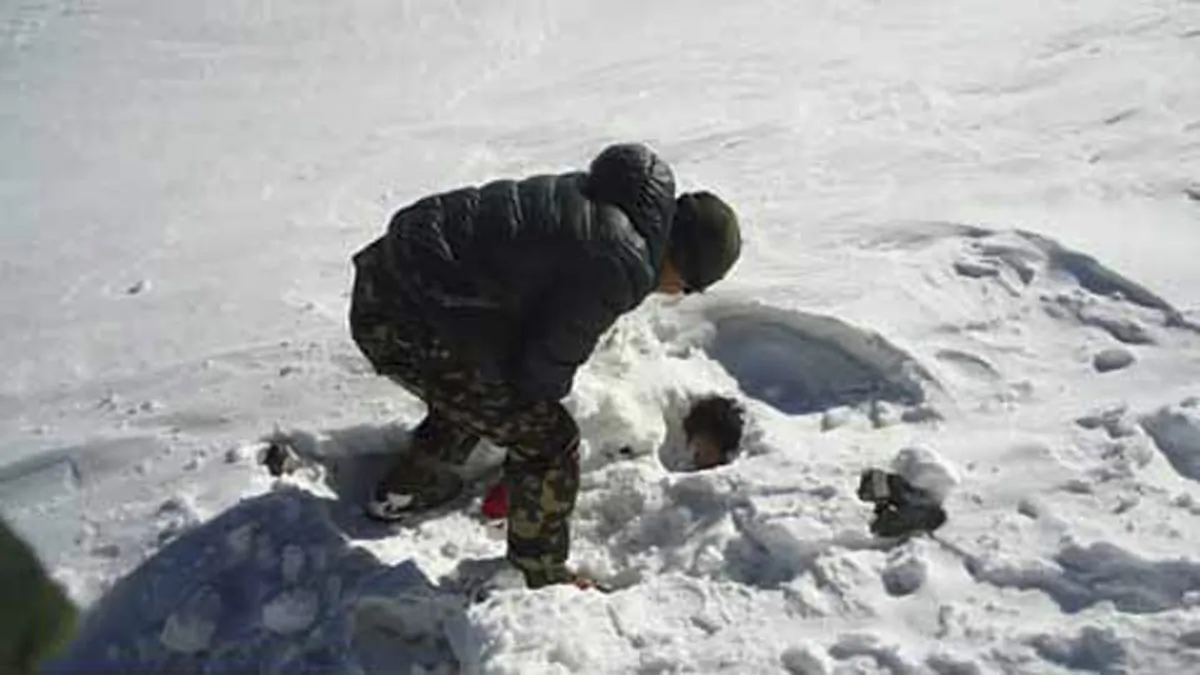 A Nepalese army soldier searches for avalanche victims at Thorong La pass area in Nepal, Sunday, Oct. 19, 2014. (AP Photo/Nepalese Army)