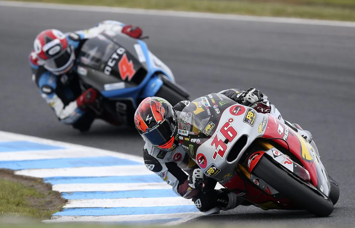 Moto2 rider Mika Kallio of Finland leads Randy Krummenacher of Switzerland into turn 10 during a free practice for Sunday's Australian Motorcycle Grand Prix at Phillip Island, Australia, Saturday, Oct. 18, 2014. (AP Photo/Rob Griffith)