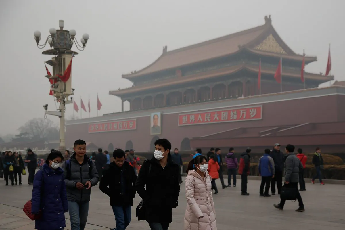 Chinese tourists wear masks on Tiananmen Square during severe pollution on Feb. 25, 2014 in Beijing, China. (Lintao Zhang/Getty Images)