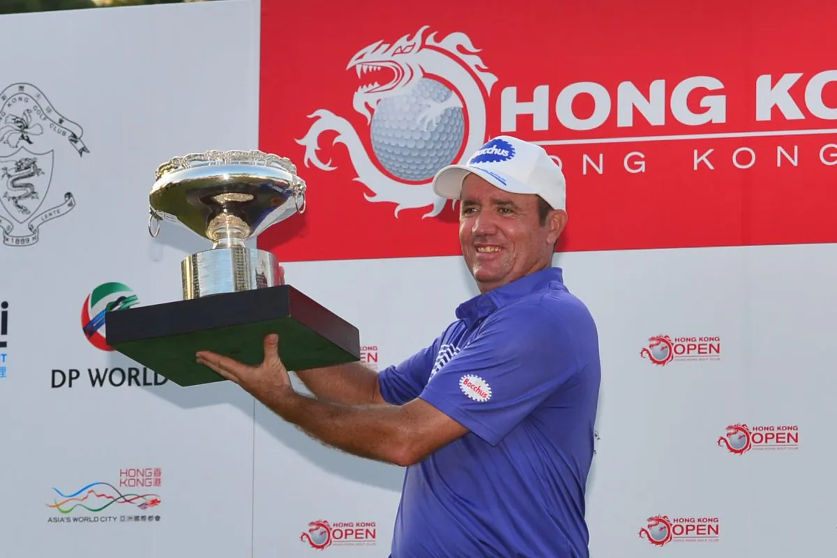 Scott Hend of Australia holds the Hong Kong Open 2014 winner’s trophy after the presentation on Sunday Oct 19. Hend beat Angelo Que in a playoff to win the title. (Bill Cox/Epoch Times)
