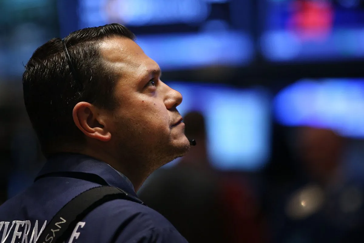 A trader works on the floor of the New York Stock Exchange (NYSE) on Oct. 21, 2014, in New York City. Despite news of a slight slowdown in the Chinese economy, the Dow rose again today, finishing up over 200 points. (Spencer Platt/Getty Images)