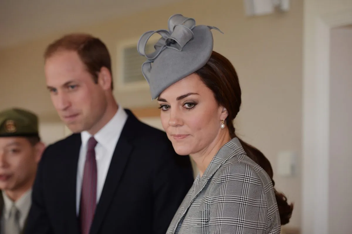 Britain's Prince William, left, and his wife, Kate, Duchess of Cambridge, wait to greet the President of Singapore, Tony Tan Keng Yam, and his wife Mary,  at an hotel in London, on the first day of his four-day state visit to the Britain, Tuesday, Oct. 21, 2014. (AP Photo/Anthony Devlin, Pool)