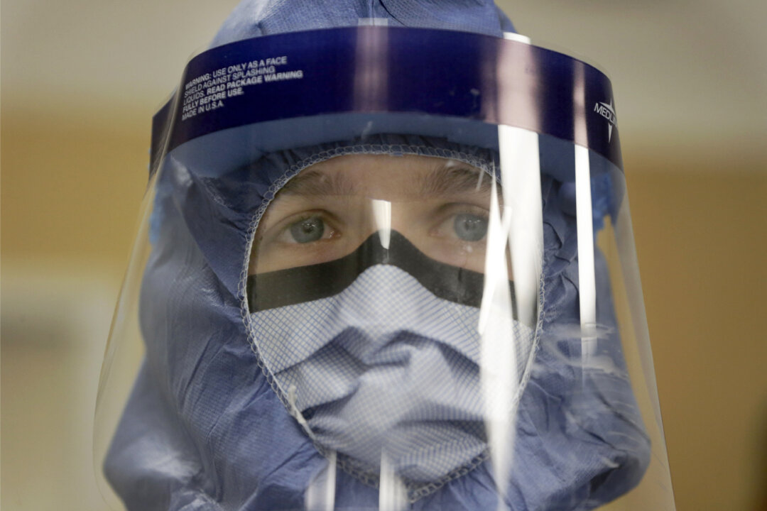 Registered nurse Keene Roadman stands fully dressed in personal protective equipment during a training class at the Rush University Medical Center, in Chicago, on Oct. 16, 2014. The Centers for Disease Control and Prevention released new guidelines Monday, Oct. 20, for how health workers should gear up to treat Ebola patients. (AP Photo/Charles Rex Arbogast)