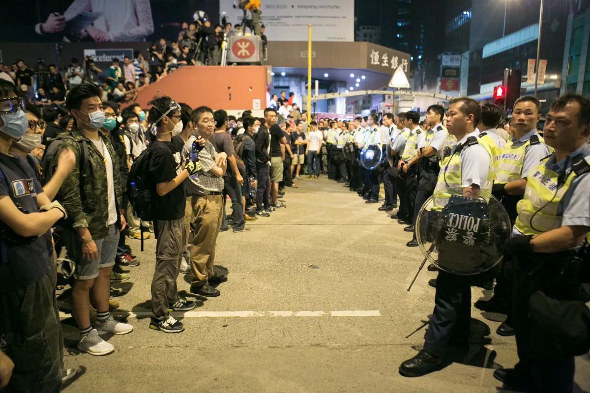 Pro-democracy protesters stand off with the police after they were trying all night to shutdown parts of Argyle Street and Nathan Road in Mong Kok, Hong Kong, on Oct. 18, 2014. (Benjamin Chasteen/Epoch Times)