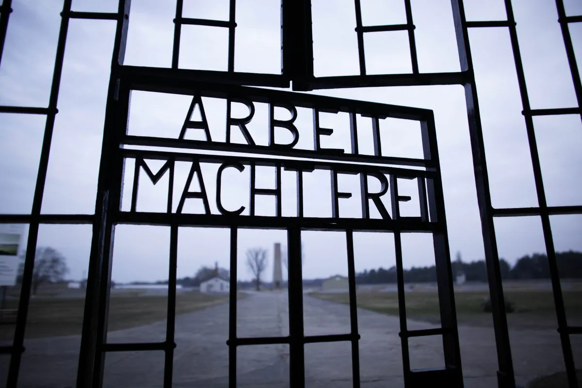 This photo shows the words “Arbeit Macht Frei” (Work Sets You Free) at the main entrance of the Sachsenhausen Nazi concentration camp on the international Holocaust remembrance day in Oranienburg, Germany.  (Markus Schreiber/AP Photo)