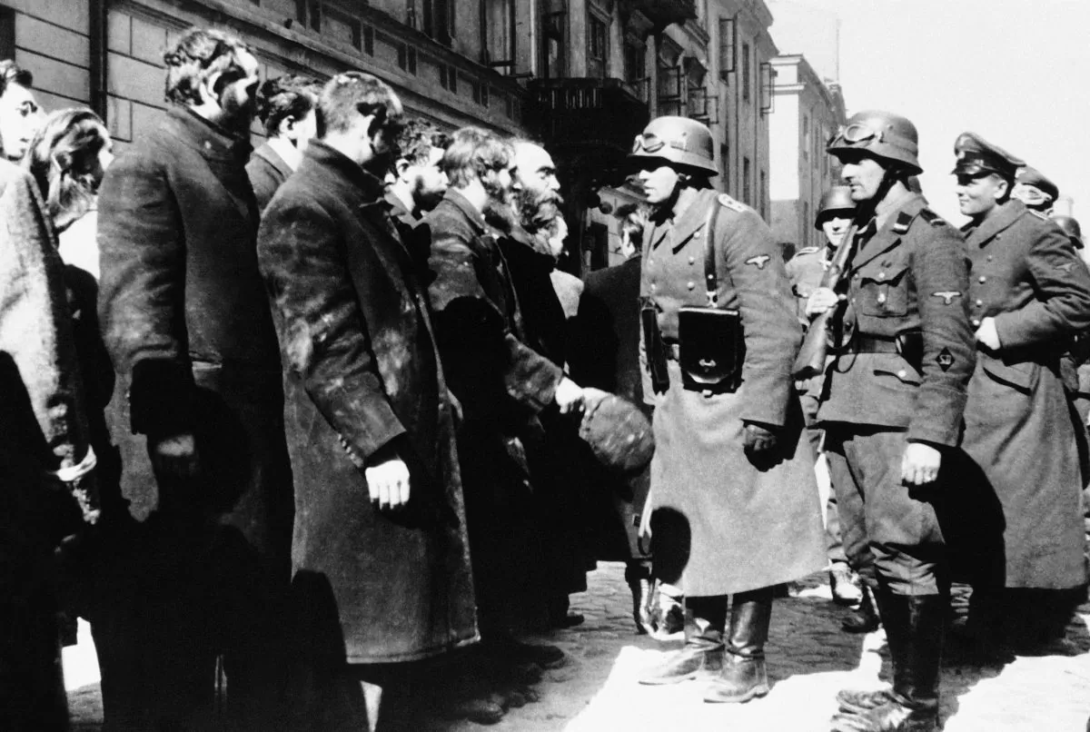 Nazi officers talking with citizens of the Warsaw ghetto in Poland on 1943. (AP Photo)