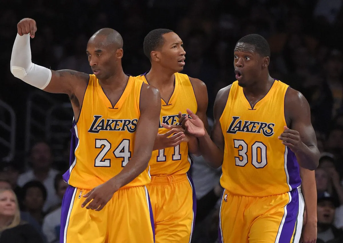 Los Angeles Lakers guard Kobe Bryant, left, gestures to count a basket as forward Wesley Johnson, center, and forward Julius Randle react as referees nullify it during the second half of a preseason NBA basketball game against the Utah Jazz, Sunday, Oct. 19, 2014, in Los Angeles.  The Lakers on 98-91. (AP Photo/Mark J. Terrill)