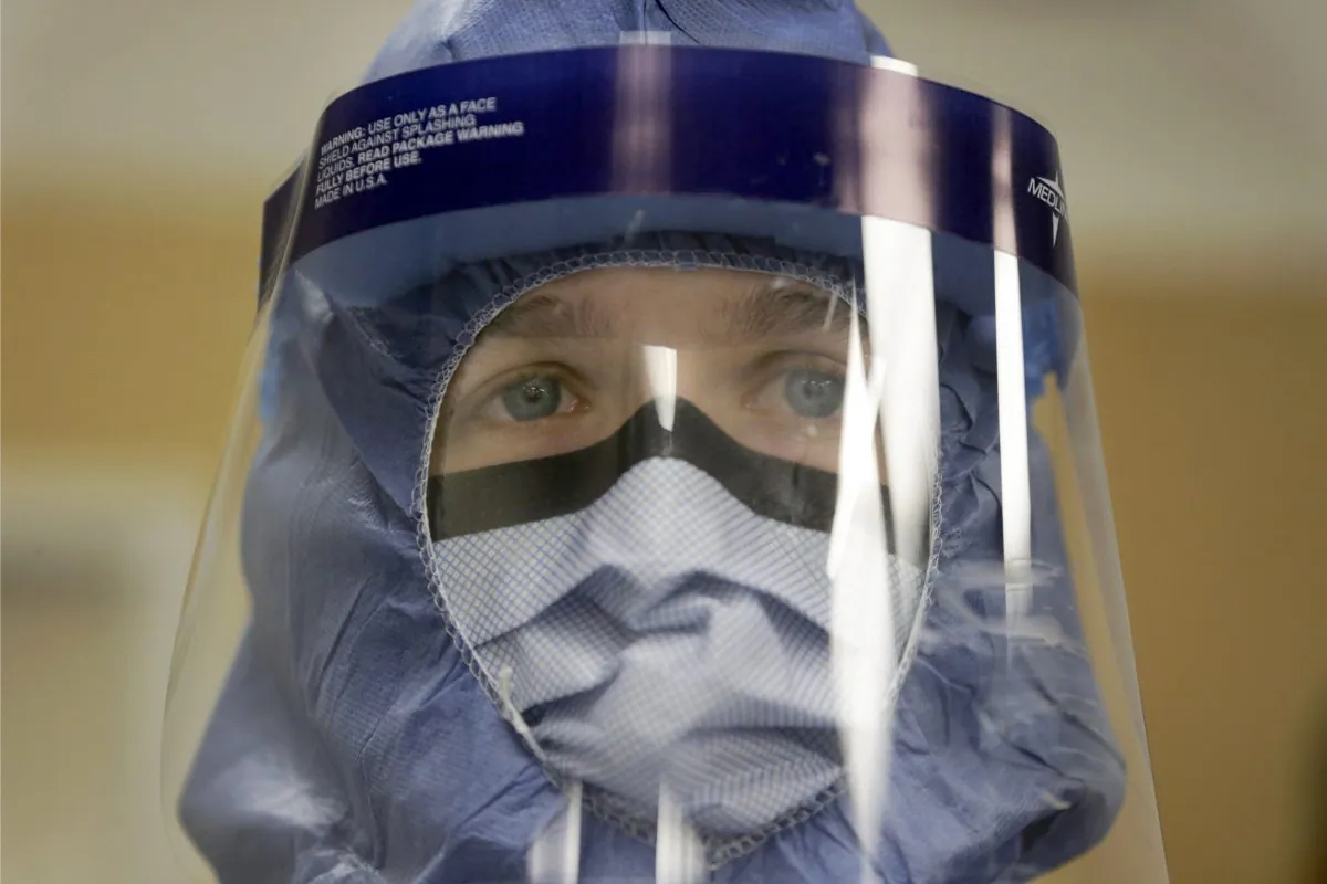 Registered nurse Keene Roadman stands fully dressed in personal protective equipment during a training class at the Rush University Medical Center, in Chicago, on Oct. 16, 2014. The Centers for Disease Control and Prevention released new guidelines Monday, Oct. 20, for how health workers should gear up to treat Ebola patients. (AP Photo/Charles Rex Arbogast)