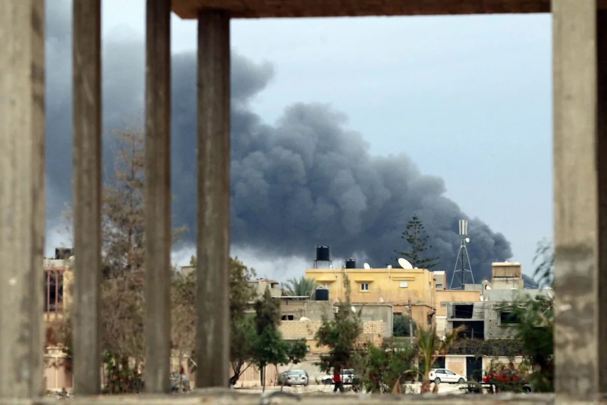 The Libya's eastern coastal city of Benghazi shows smoke billowing from buildings after Libyan airforce, loyal to former general Khalifa Haftar, pounded them as they were reportedly storing ammunition belonging to Benghazi-based Islamist Ansar al-Sharia group, on Oct. 22, 2014. Fierce fighting have been raging for days in several parts of Libya's second city between pro-government forces led by Haftar and Islamist militias. (Abdullah Doma/AFP/Getty Images)