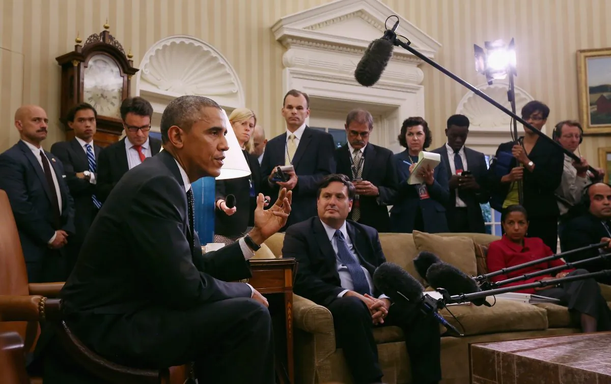 US President Barack Obama (L) talks with reporters after a meeting with Ebola Response Coordinator Ron Klain (C) and National Security Advisor Susan Rice (R) in the Oval Office at the White House October 22, 2014, in Washington, DC. Obama said the federal government is working day and night to make the American people safe. (Chip Somodevilla/Getty Images)