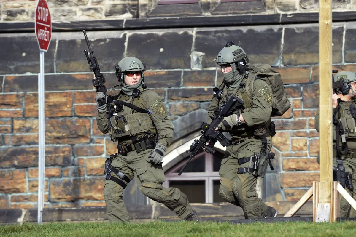 A Royal Canadian Mounted Police intervention team responds to a reported shooting at Parliament building in Ottawa, Wednesday, Oct. 22, 2014. (AP Photo/The Canadian Press, Adrian Wyld)