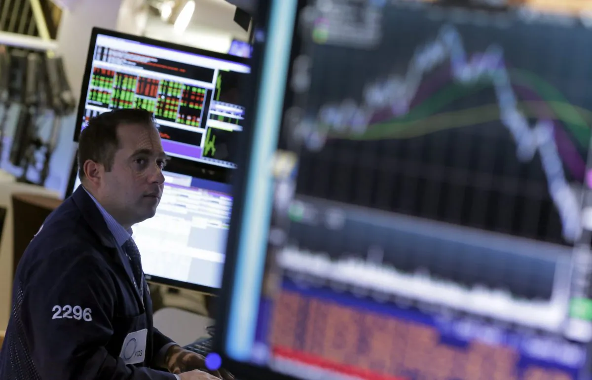 A specialist works at his post on the floor of the New York Stock Exchange Wednesday, Oct. 22, 2014. Stocks are opening mixed as investors look over earnings reports from US companies. (AP Photo/Richard Drew)