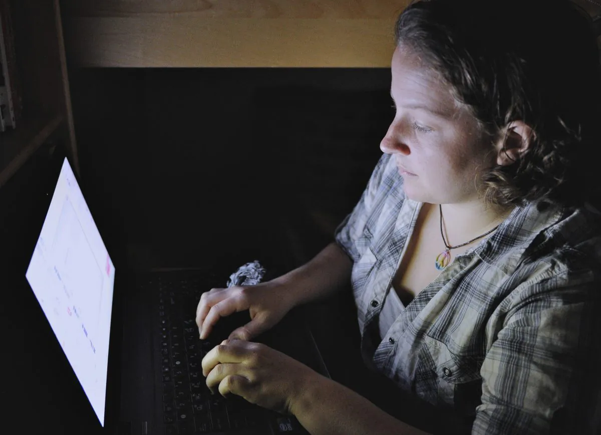 Catherine Devine, 22, reads instant messages on her laptop screen at her home in Kings Park, NY, on Sept. 26, 2011. Devine had her first of several brushes with online harassment in seventh grade, before she'd even ventured onto the Internet. A report released Wednesday, Oct. 22, 2014, by the Pew Research Center found that nearly three-quarters of American adults who use the Internet have witnessed online harassment. Forty percent have experienced it themselves. (AP Photo/Kathleen Malone-Van Dyke)