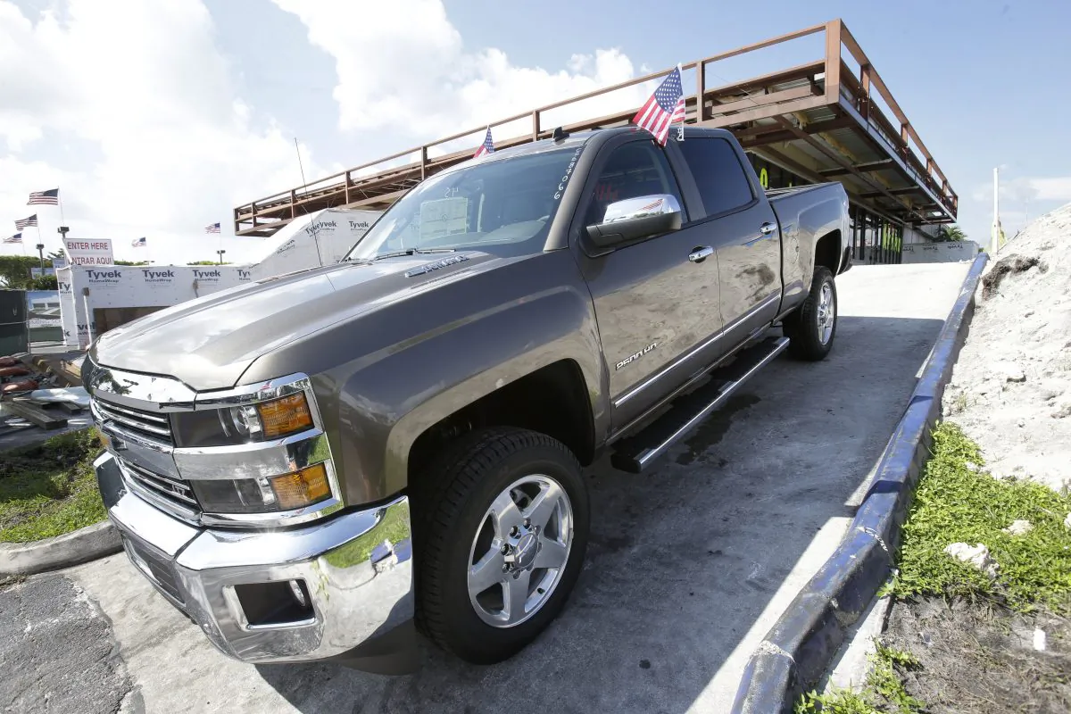 in this Oct. 1, 2014 file photo, a 2015 Chevrolet Silverado 2500 4WD LTZ Crew Cab pickup truck is on display at Miami Lakes AutoMall in Miami Lakes, Fla. General Motors reports quarterly earnings on Thursday, Oct. 23, 2014. (AP Photo/Wilfredo Lee)