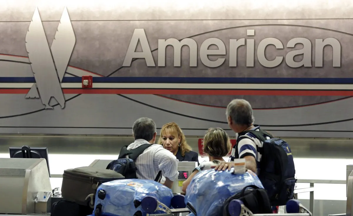 Passengers check in at the American Airlines counter at Miami International Airport in Miami on May 27, 2014. American Airlines reports quarterly financial results on Thursday, Oct. 23, 2014. (AP Photo/Alan Diaz)